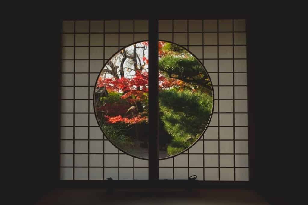 Window in Japanese style with view of trees in autumn